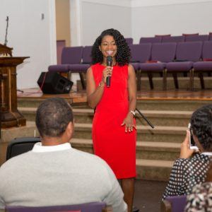 Our founder Kahlida speaking to attendees at a church-hosted event.