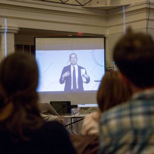 Close-up of people intently watching a slideshow presentation on answering the call to be a reconciler.