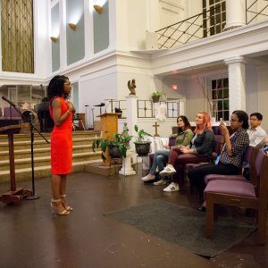 Our founder Kahlida addressing several attendees of a church-hosted event.