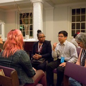 People sitting in a circle and discussing racial divides at a church-hosted event.