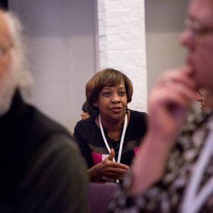 Attendees of a racial reconcilation event speaking with one another about reconciliation.