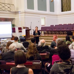 People listening to a talk on social justice at a church-hosted event in New Orleans.